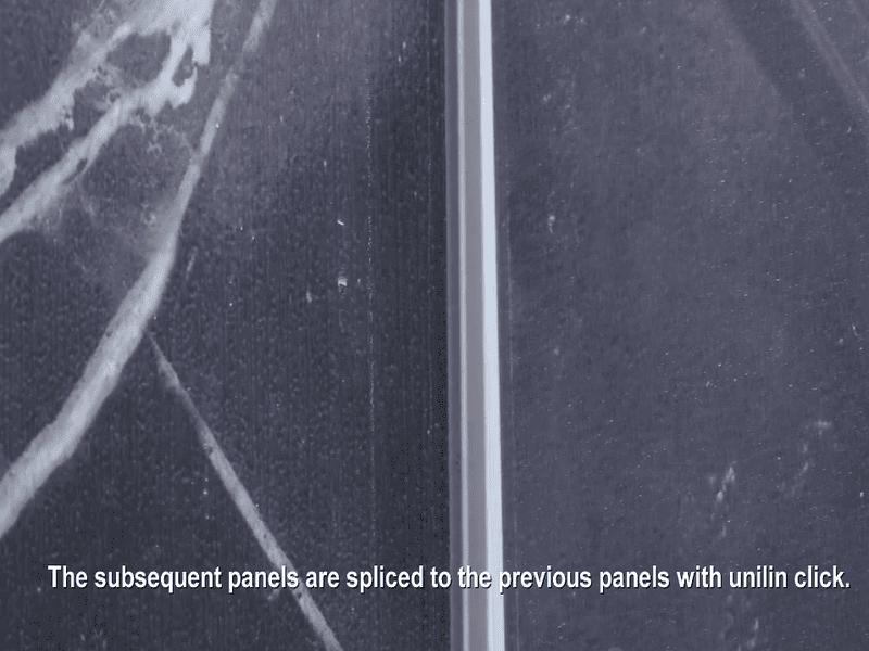 Close-up of SPC wall panels being joined with click-lock system