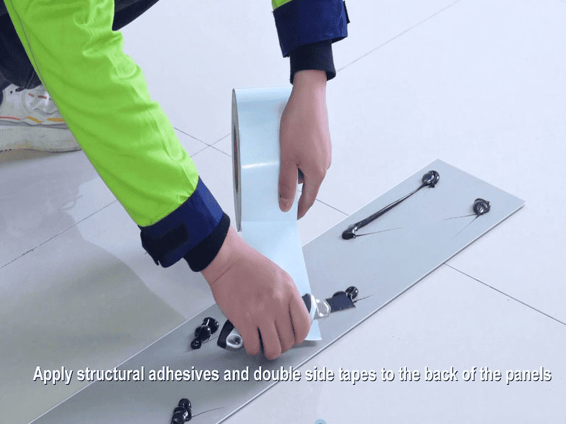 Applying silicone sealant and double-sided tape to SPC wall panel for installation