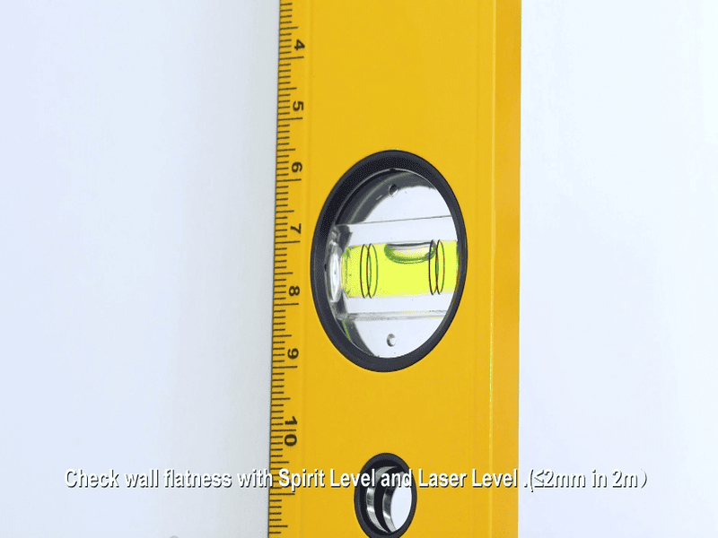 Spirit level checking wall flatness for SPC wall panel installation