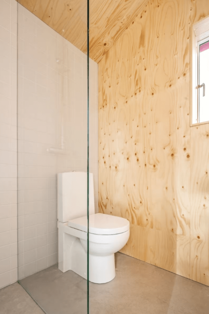 Water-resistant plywood bathroom wall panel with natural wood veneer finish
