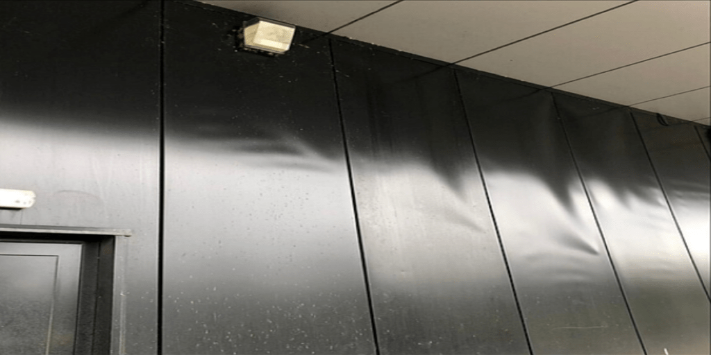 Close-up photo of an SPC wall panel surface showing blistering caused by moisture issues